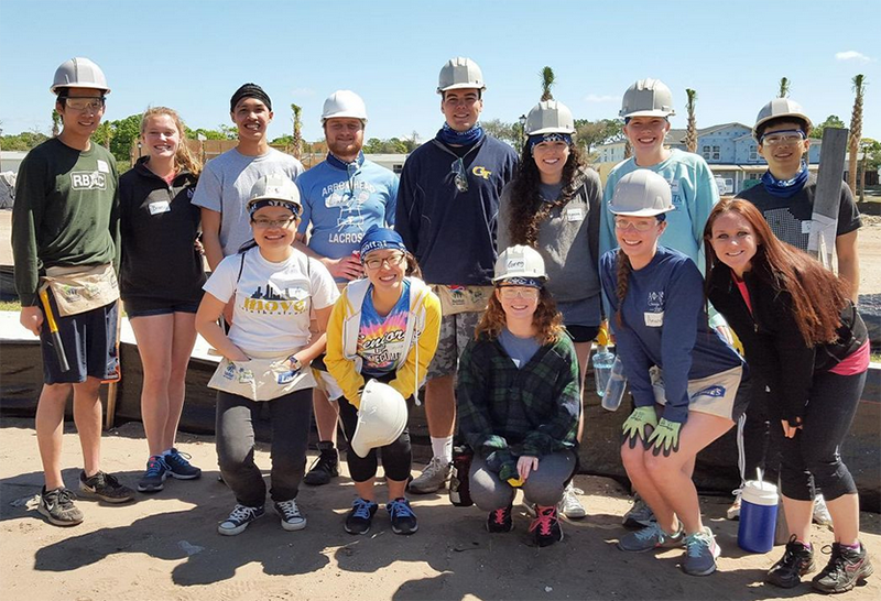 A group of GT students wearing hard hats during an Alternative Service Break.
