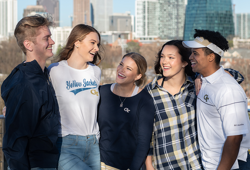 A group of GT students with the Atlanta skyline as their backdrop.